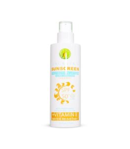 Woman applying Orgakera Sunscreen SPF 50 on face under bright sun