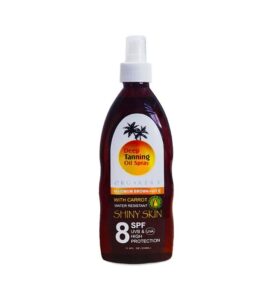 Tanning Oil Spray SPF 8 bottle on sandy beach background