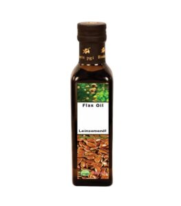 Organic Flax Seed Oil Bottle by NAKAA on a rustic wooden surface