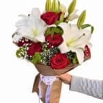Romantic flower bouquet with red roses and white lilies