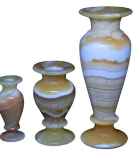 Egyptian alabaster vase used as a flower holder on a table