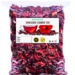 Dried hibiscus petals in a wooden bowl for herbal tea