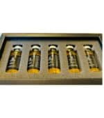 Close-up of 24K gold collagen serum in glass ampoule