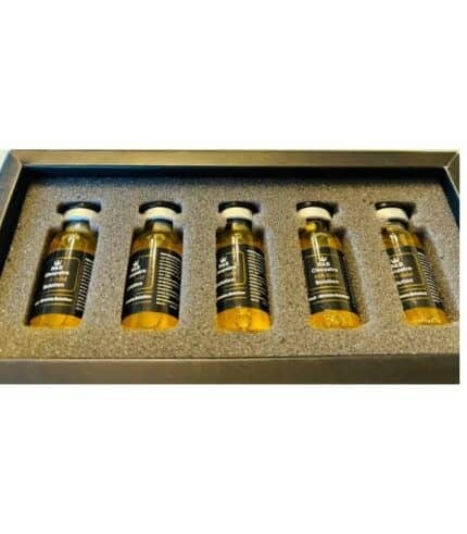Close-up of 24K gold collagen serum in glass ampoule