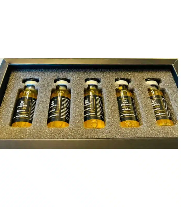 Close-up of 24K gold collagen serum in glass ampoule